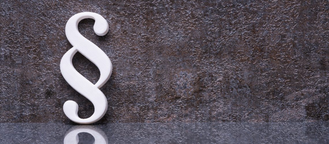 Close-up Of A Paragraph Symbol Leaning On Dark Wall